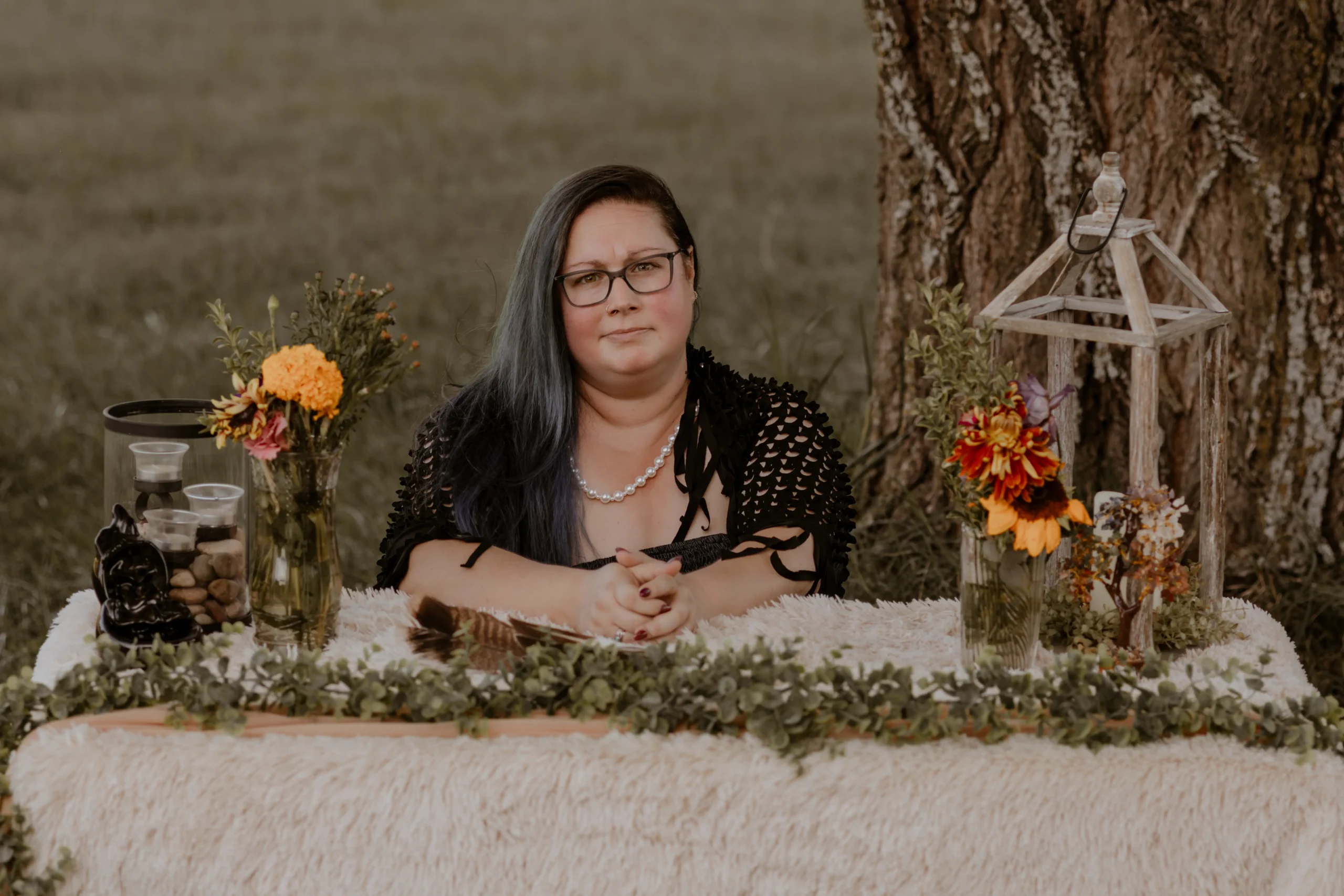 Beth seated at a table in a welcoming space.