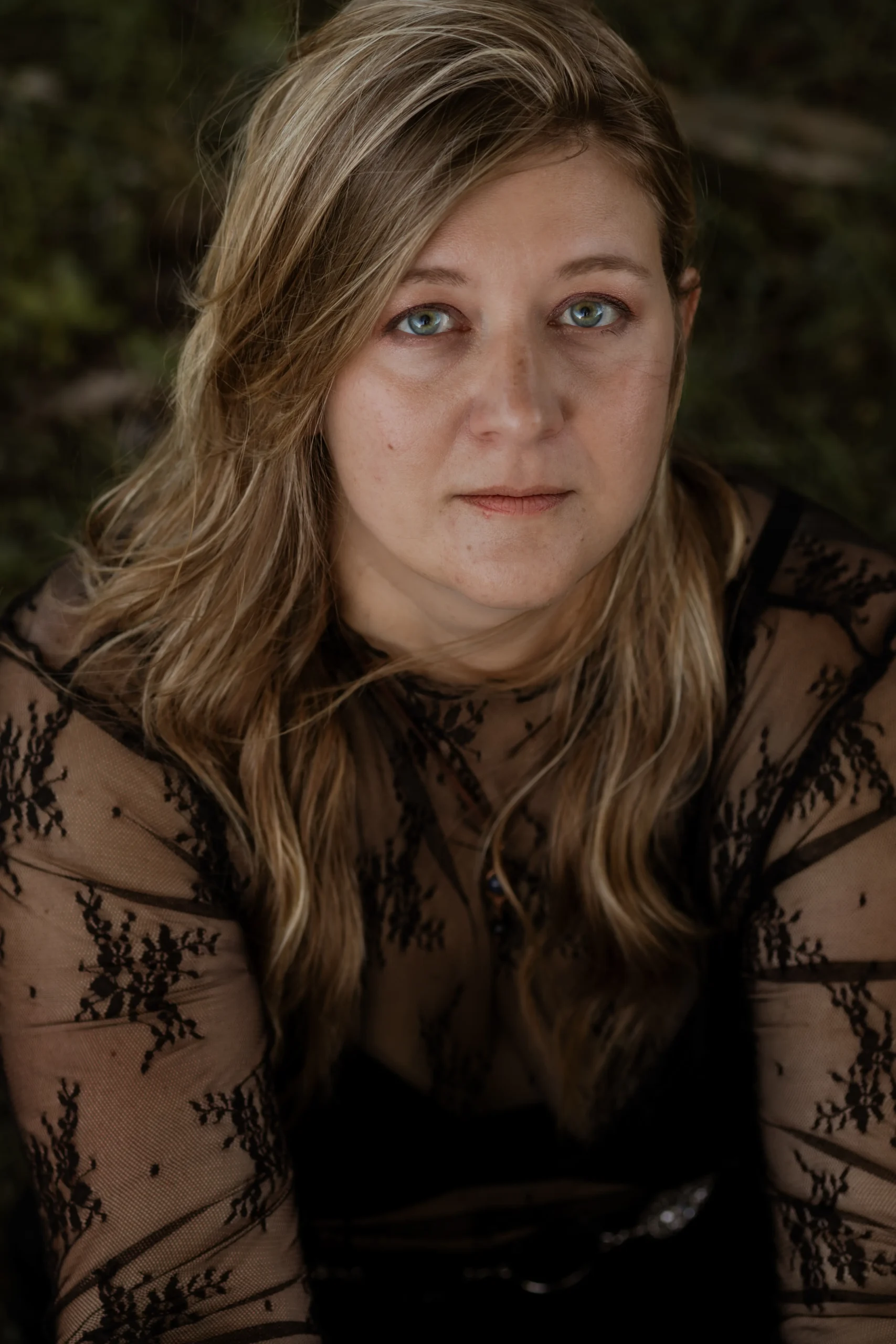 Kristen of The Mystic Sisters in a peaceful outdoor portrait.