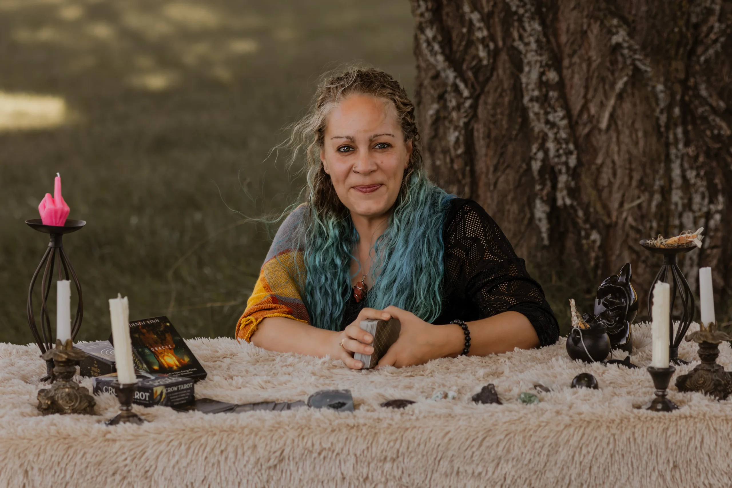 Cyndi of The Mystic Sisters seated with her tarot materials.
